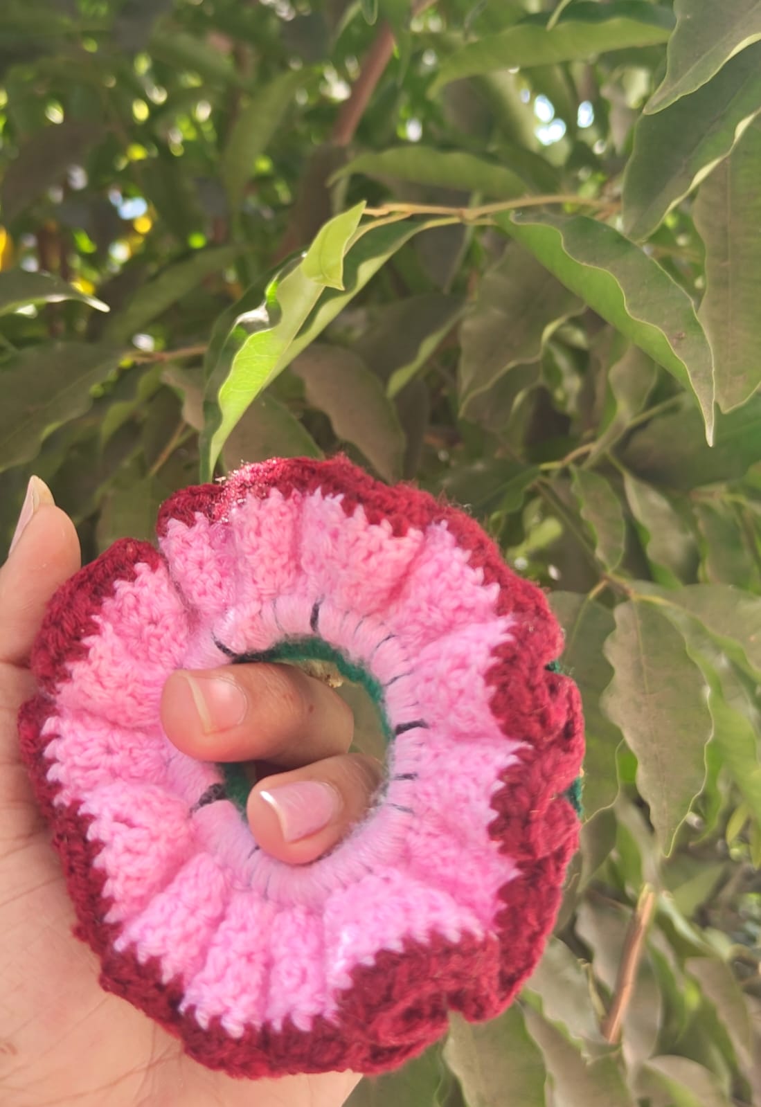 Large structured pink hair bow crocheted in moss stitch with a secure metal clip.