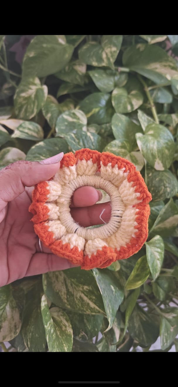 Tiny amigurumi acorn keychain with a textured brown cap and tan body.