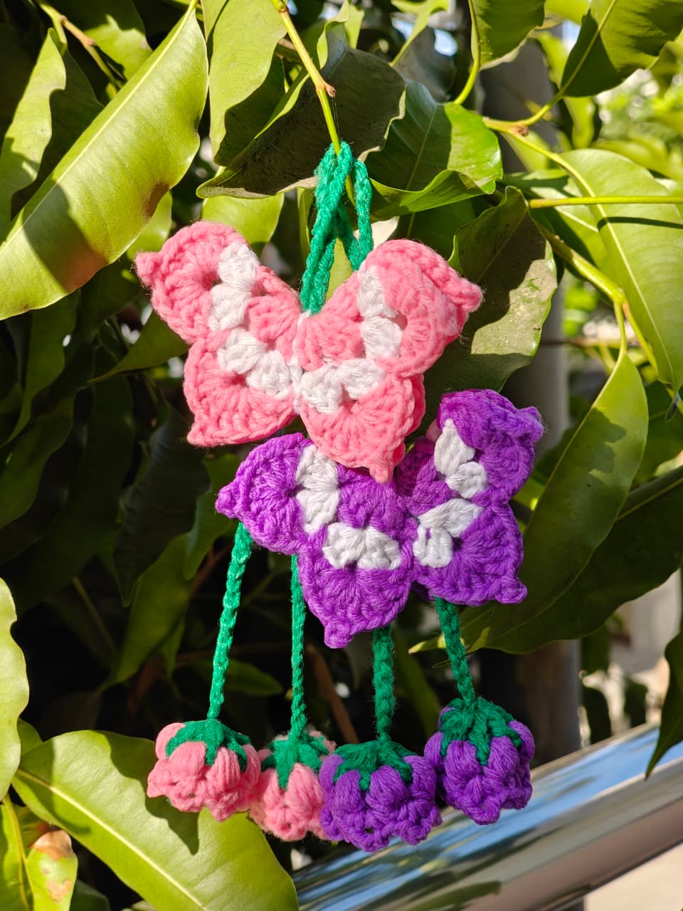 Voluminous crochet scrunchie in soft lilac, yellow, and baby pink variegated yarn.